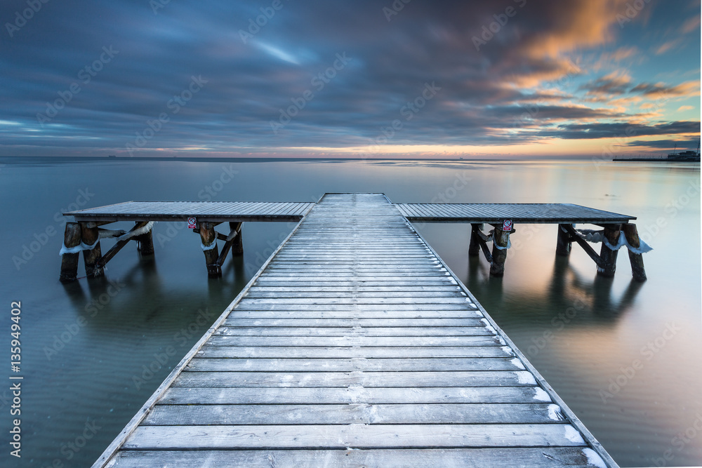 Early morning at frozen small pier at beach in Sopot. Winter landscape in Sopot, Poland.