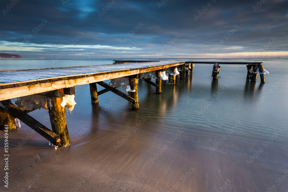 Early morning at frozen small pier at beach in Sopot. Winter landscape in Sopot, Poland.