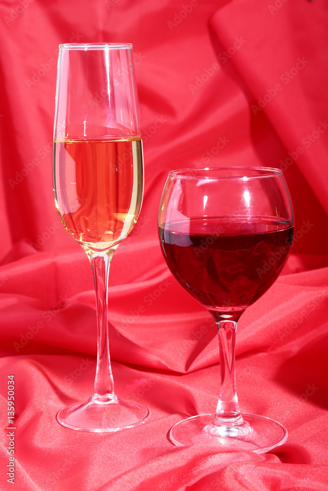 Celebration composition with two glasses white wine grapes on red backgroumd. Celebration composition with two glasses white wine grapes on red backgroumd.