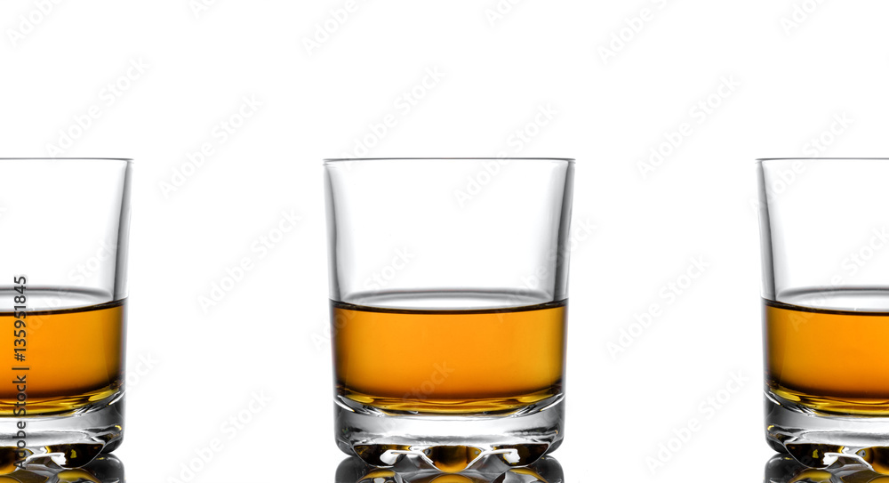 Three glasses of whiskey on a white background Three glasses of whiskey on a white background