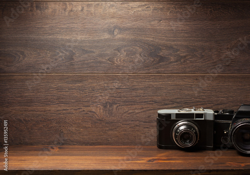 old camera at shelf wall wood