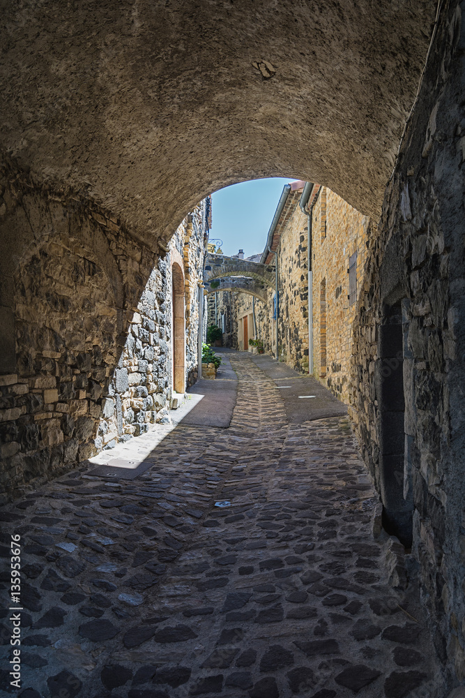 Pedestrian road under the houses  in the picturesque village of Mirabel.in the Ardeche department in France.