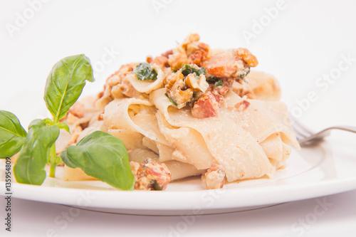 Pasta with cream sauce with bacon, mushrooms, walnuts, spinach