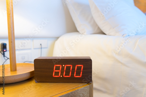 Alarm clock work time on the bed 8 am.