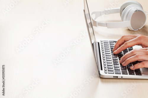 Woman working on laptop. Hands typing on keyboard.