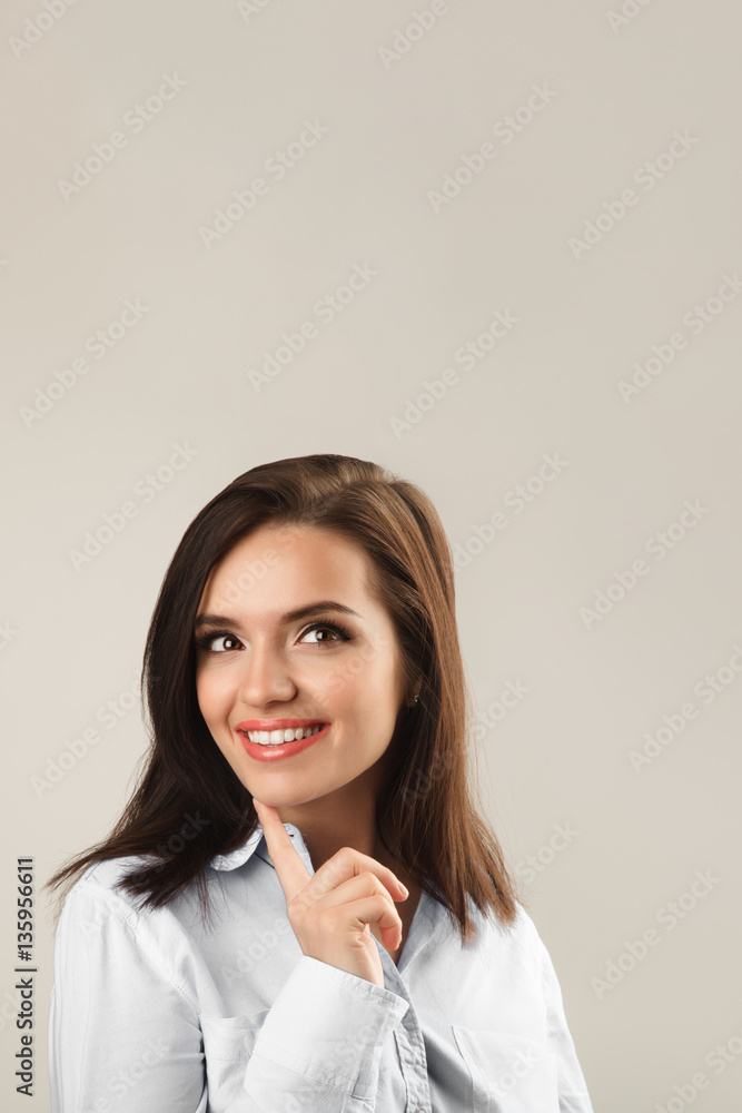 Cheerful beautiful young business woman in white shirt thinking Cheerful beautiful young business woman in white shirt thinking