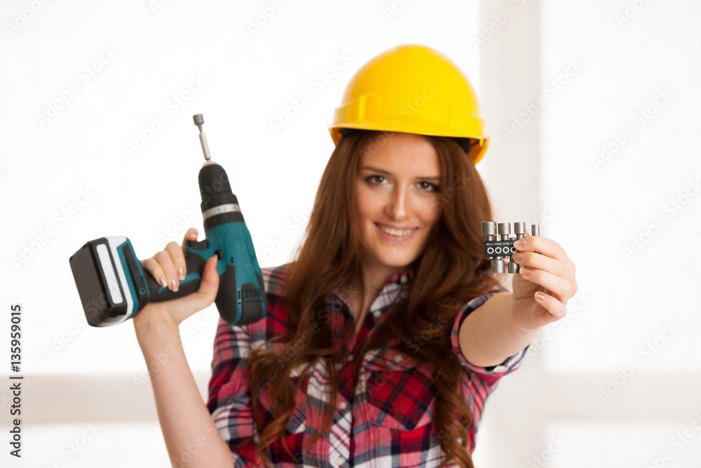 Confident woman works with batery drill machine DIY Confident woman works with batery drill machine DIY