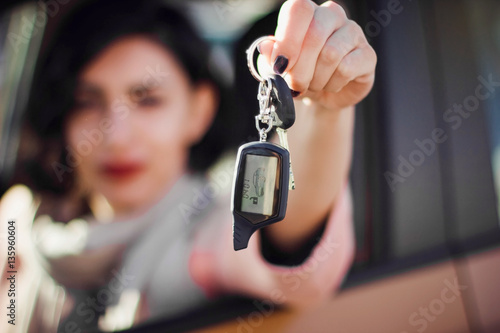 Happy smiling woman with car key