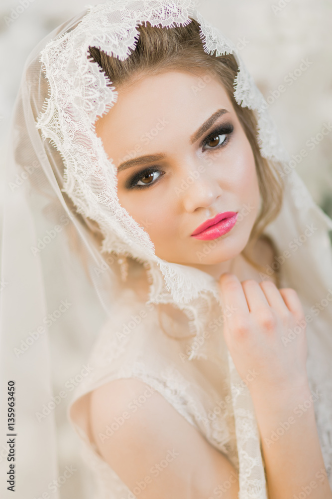Bride.Young fashion model with perfect skin and make up, loft background, curly hair Bride.Young fashion model with perfect skin and make up, loft background, curly hair