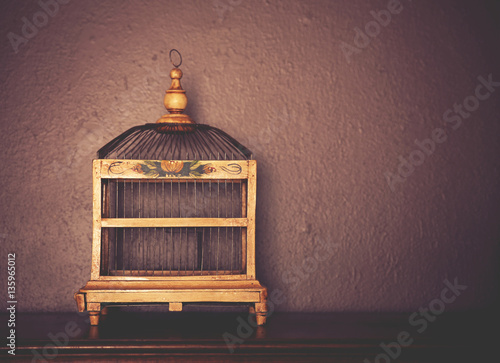 Tablou canvas a birdcage on top of a piano toned with a retro vintage instagr