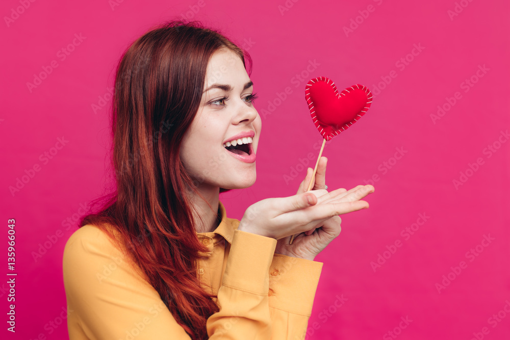 woman with a red heart in her hand, a wooden stick woman with a red heart in her hand, a wooden stick