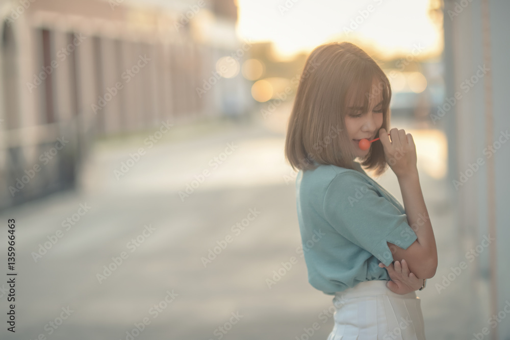 Fototapeta premium Portrait Happy with brown hair woman eating candy