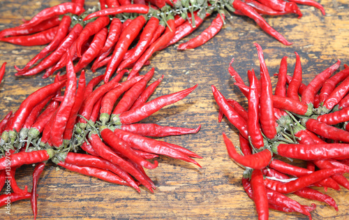 red hot peppers on wooden table at market