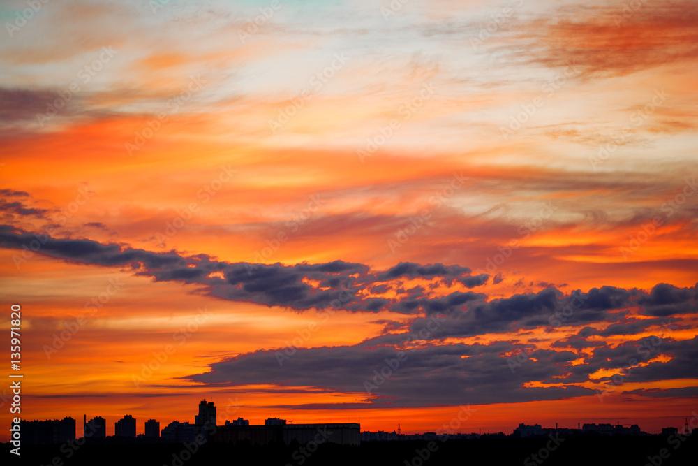 Naklejka premium Sunrise in city landscape. Urban sunset. Rays of the sun above t