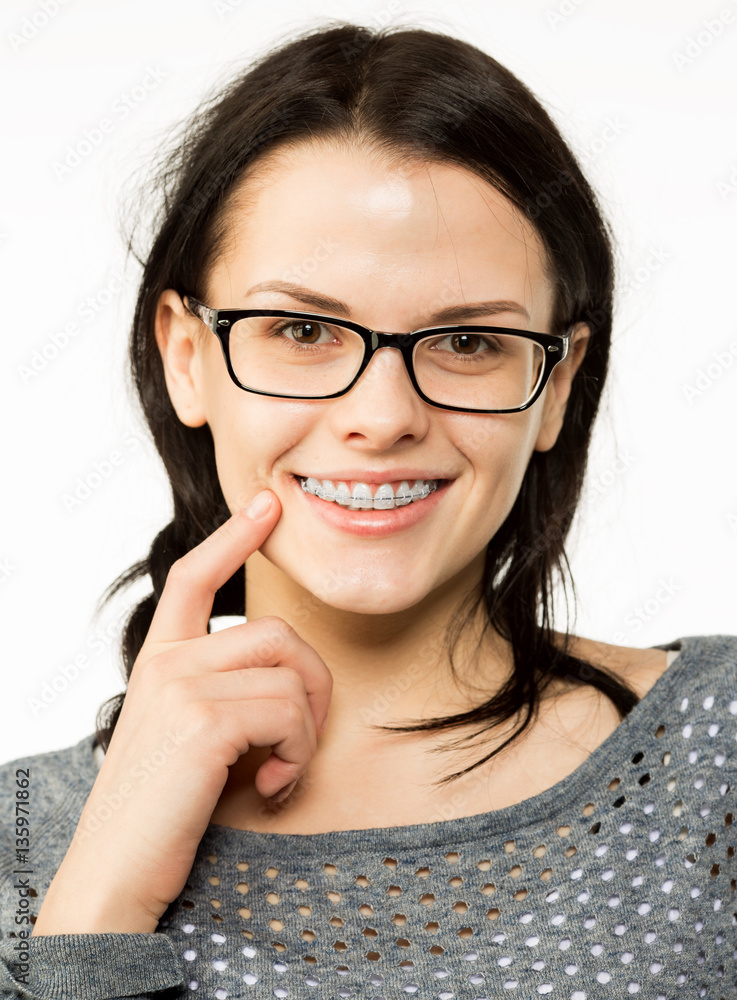 Nerd girl in glasses and with brackets on teeth. Positive, excellent student woman hipster. Nerd girl in glasses and with brackets on teeth. Positive, excellent student woman hipster.
