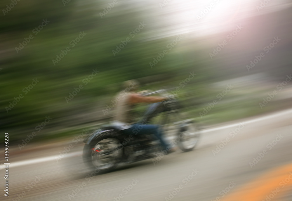biker on mountain highway, riding around a curve with a motion b biker on mountain highway, riding around a curve with a motion b