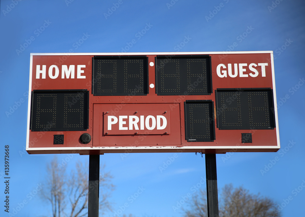 a scoreboard with home and guests written on it in front of a bl