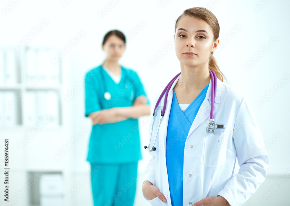 Attractive female doctor in front of medical group Attractive female doctor in front of medical group