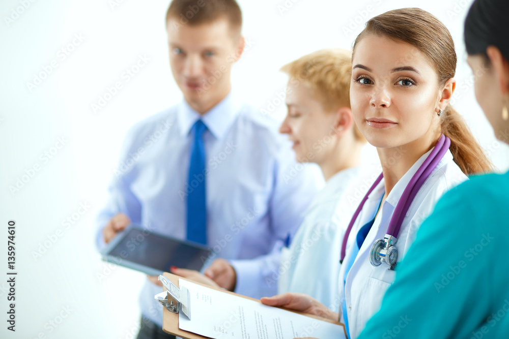 Attractive female doctor in front of medical group Attractive female doctor in front of medical group