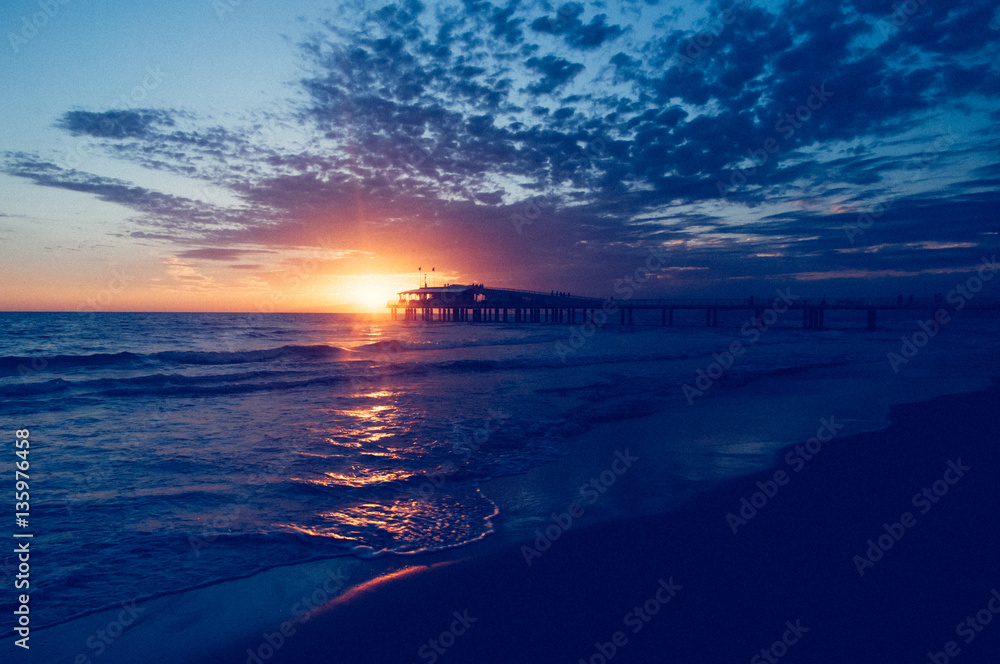 Fototapeta premium Sunset over the pier of Lido di Camaiore, Italy