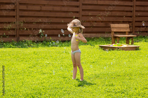 little girl playing with soap bubbles