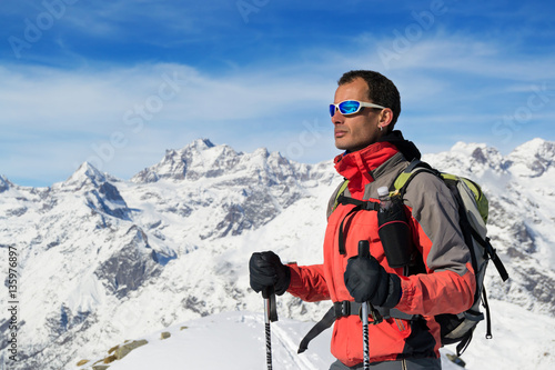 Man mountain winter clothes. Ski touring in italian Alps, Gran Paradiso National Park