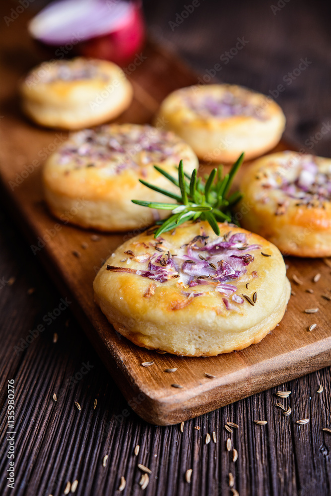 Salty pies with red onion and cumin