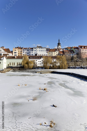 Snowy winter royal medieval Town Pisek above the frozen river Otava, Czech Republic 