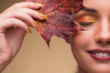 Beautiful woman in with autumn dry leaves