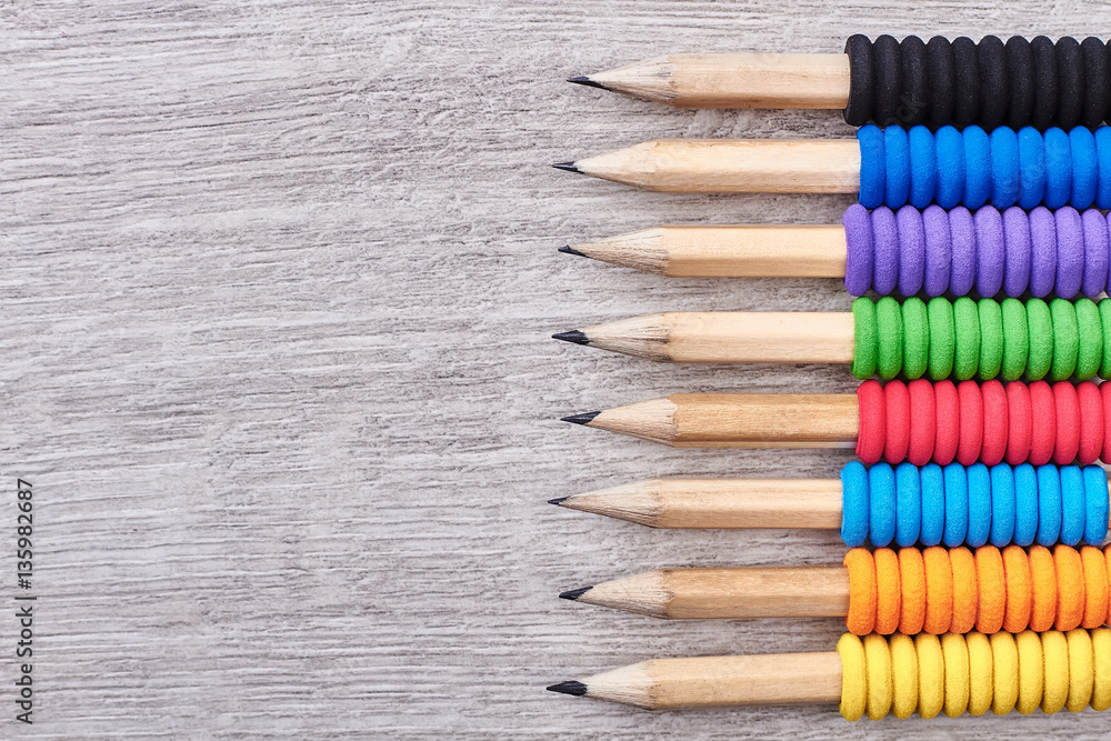 Pencils on wooden surface. Row of colourful pencils. Drawing develops imagination. Pencils on wooden surface. Row of colourful pencils. Drawing develops imagination.