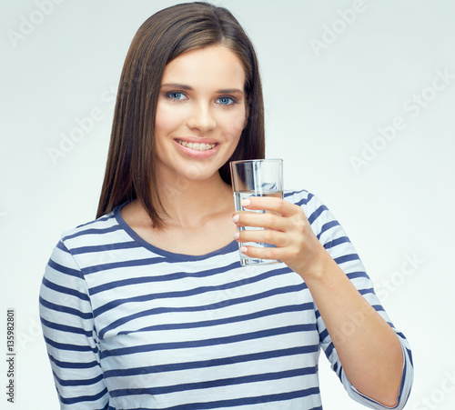 Beauty smiling young woman holding water glass.