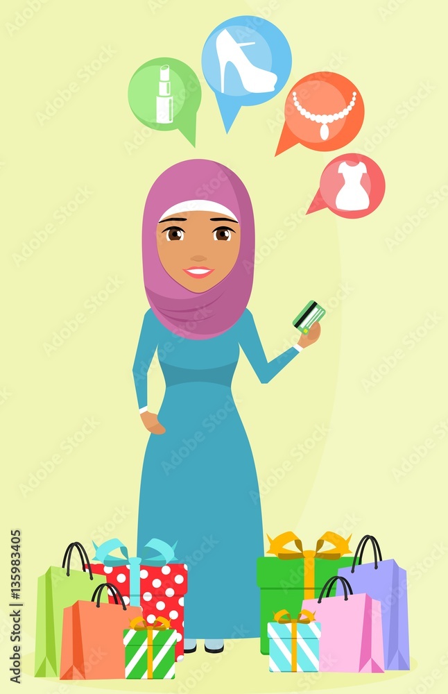 Young girl standing near shopping bags and boxes in a gift box. Arab girl. Girl holding a credit card in her hand. Happy girl. Young girl standing near shopping bags and boxes in a gift box. Arab girl. Girl holding a credit card in her hand. Happy girl.