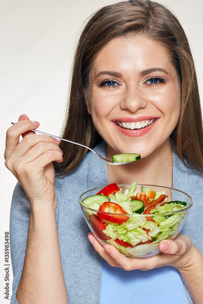 Woman eating salad. Smiling female model with long hair. Woman eating salad. Smiling female model with long hair.