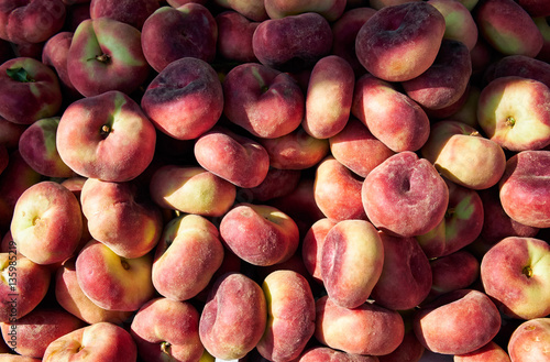 Fresh ripe saturn peaches in a market.