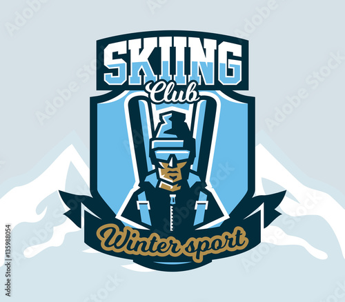 Logo skiing club. Emblem the skier in a cap and ski glasses, backpack and skis. Extreme winter sport. Isolated mountains in the background. Badges shield, lettering. Vector illustration.