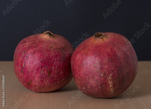 Ripe pomegranate fruit isolated on black background