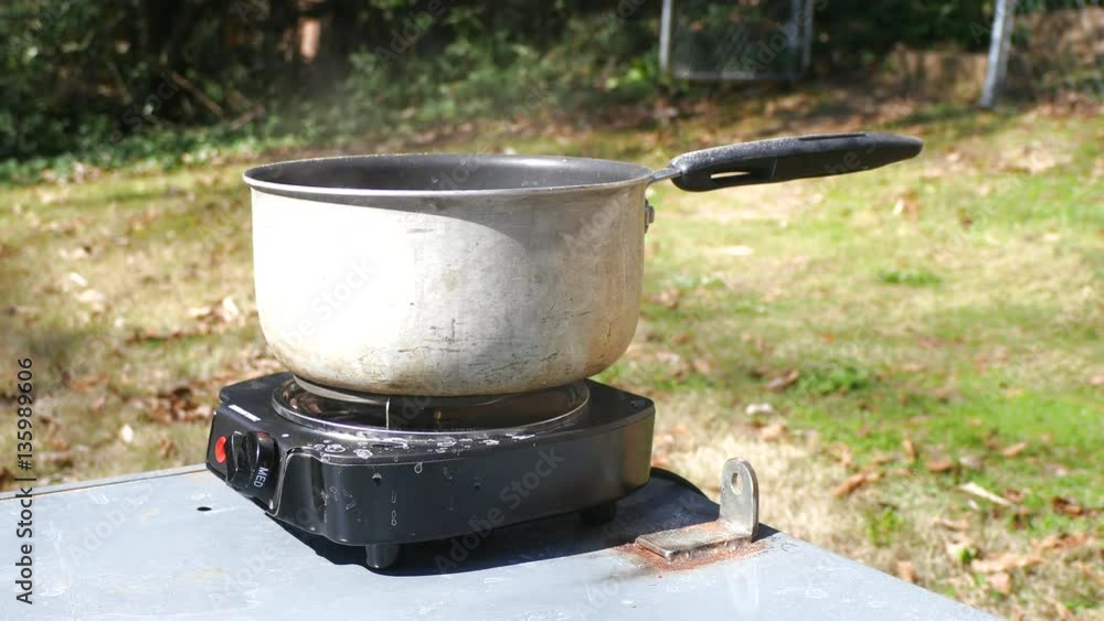 Steam Comes Off A Pot On A Hot Plate Outside Steam Comes Off A Pot On A Hot Plate Outside