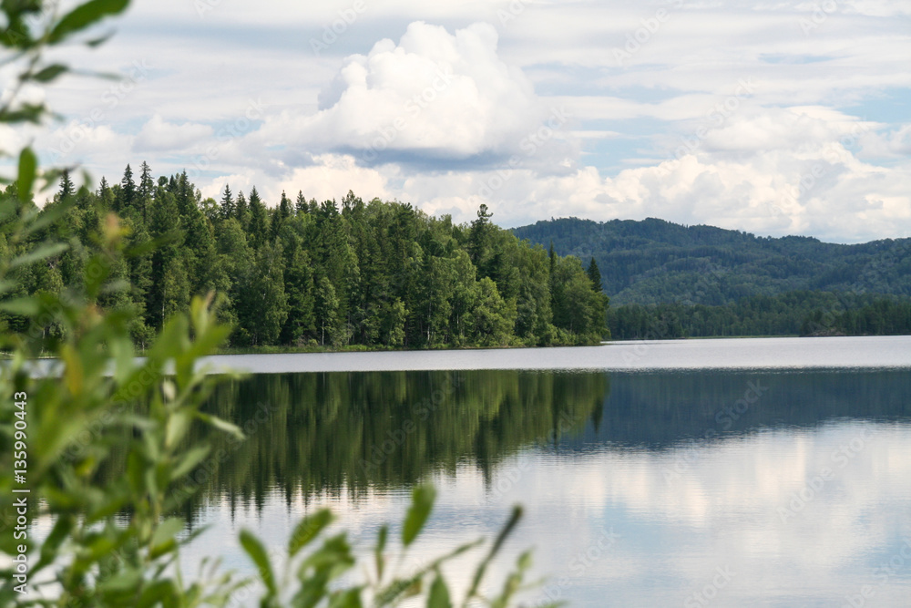 Fototapeta premium Green cape on lake. Tagasuk lake, Russia