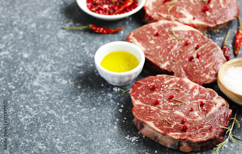 Raw fresh meat Ribeye Steak with rosemary, pepper and sea salt o