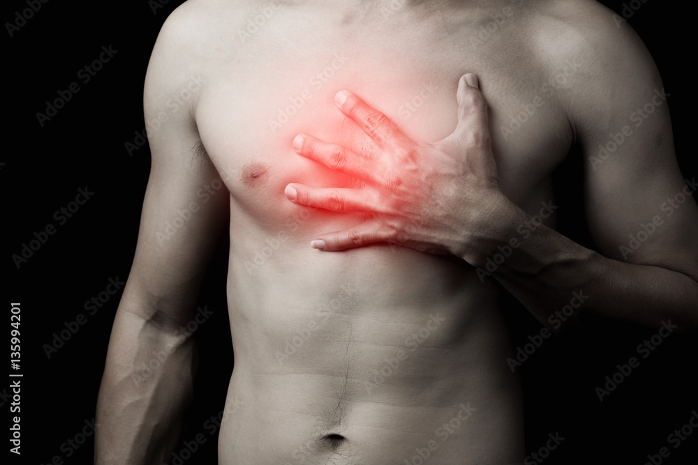 Hand of man adult touching chest with pain hurt ache on black ba