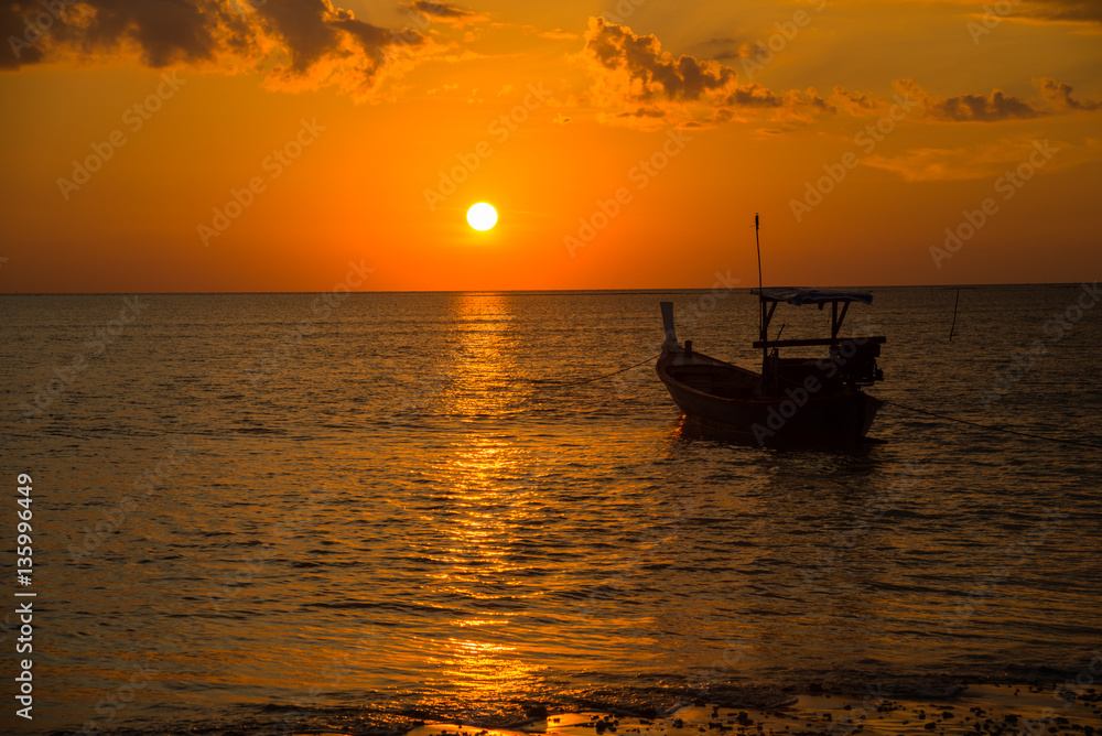 Long tailed boat at sunset