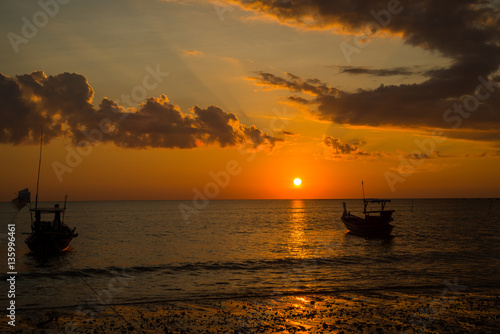 Long tailed boat at sunset