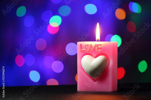 love candle on black table with blur light background, bokeh background
