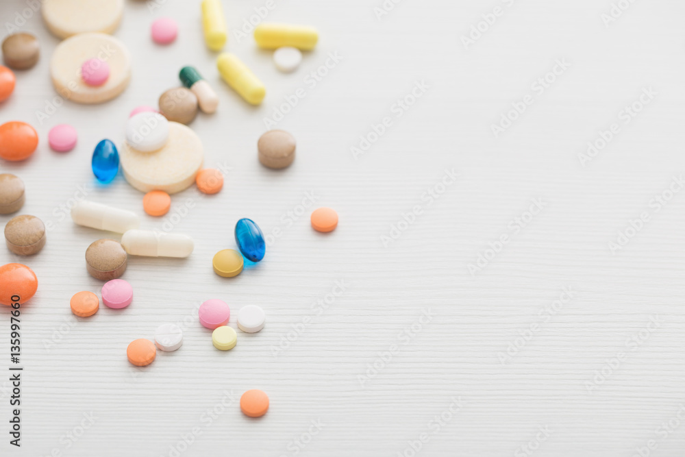 different pills mix on white wooden background different pills mix on white wooden background