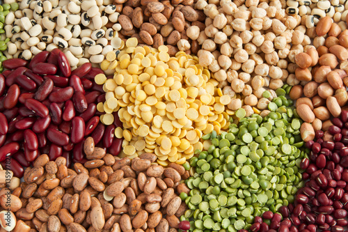 Colorful different heap of grains legumes and beans seed top view photo