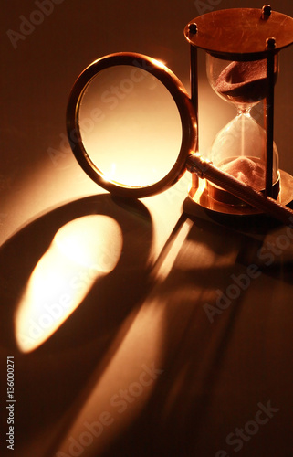 Hourglass And Magnifying Glass