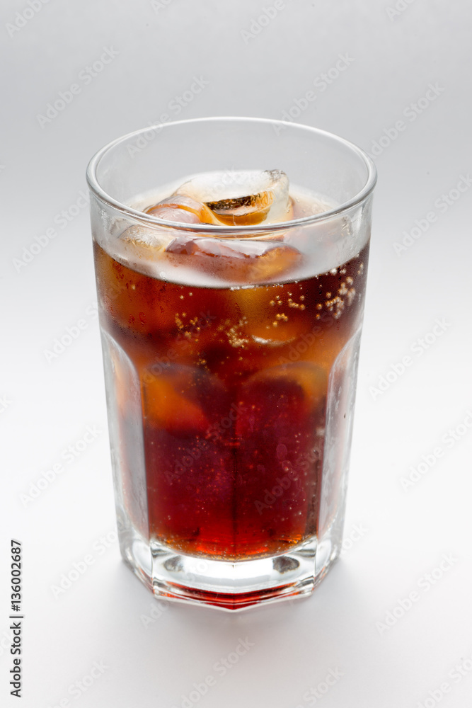 Glass with a glass of Coke rum, cocktai ice cubes Glass with a glass of Coke rum, cocktai ice cubes