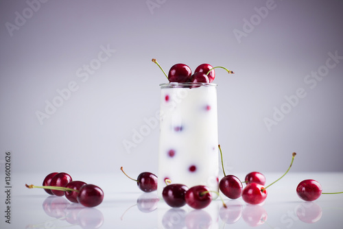 Cherries in a pot with milk on a table