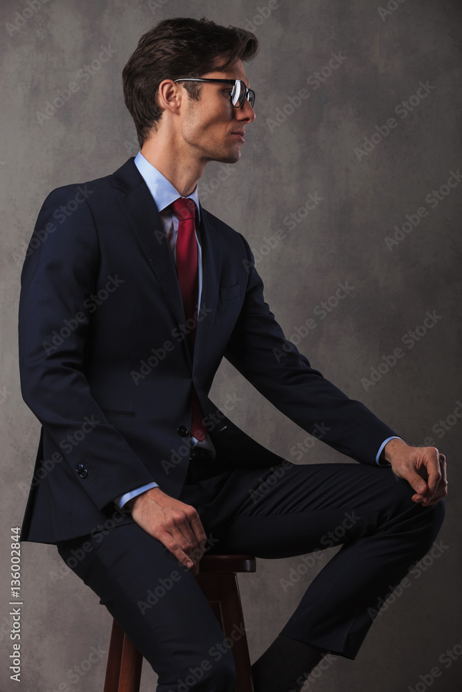 side view picture of a seated young business man side view picture of a seated young business man