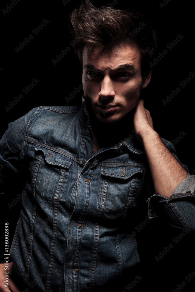 relaxed man holding hand on the back of his neck relaxed man holding hand on the back of his neck
